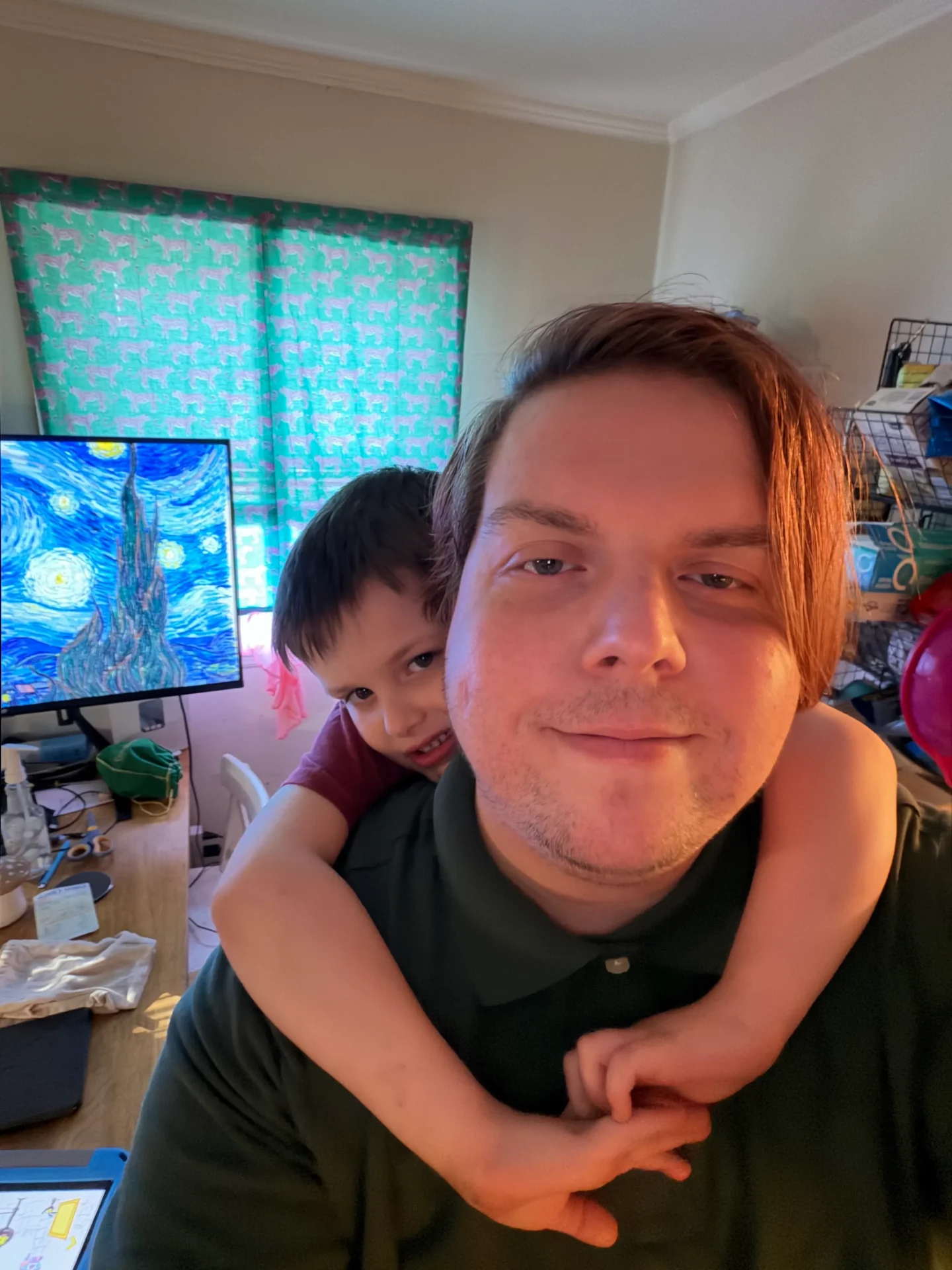 Andrew’s nephew Sam hanging from his back in the family kitchen.