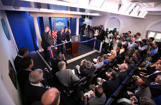 The James S. Brady Press Briefing Room at the White House with empty blue chairs and lectern