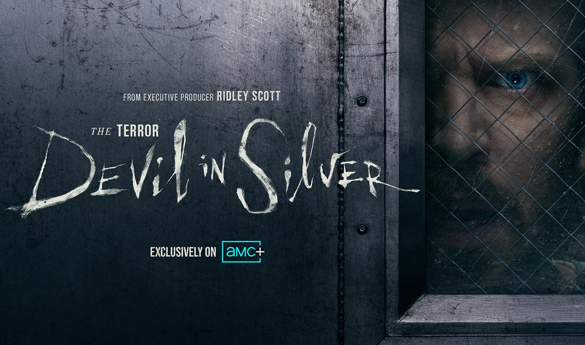 Dan Stevens peers through a wire-glass window beside The Terror: Devil in Silver title.